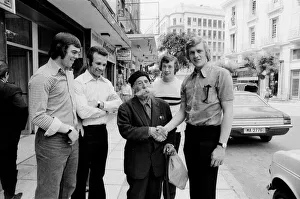 Images Dated 15th May 1973: Leeds United players meet a local man with a huge moustache as they take a walk around