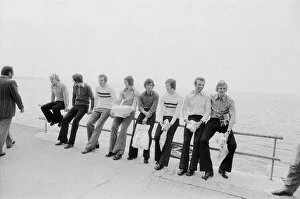 Images Dated 15th May 1973: Leeds United players sit on a railing on the promenade as they take a walk around
