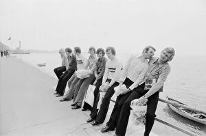 Images Dated 15th May 1973: Leeds United players sit on a railing on the promenade as they take a walk around