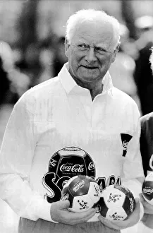 Legendary English footballer Tom Finney OBE holding a collection of Coca Cola footballs Legendary English footballer Tom Finney OBE holding a collection of Coca Cola footballs