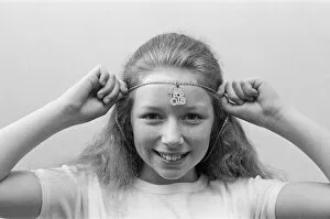 Images Dated 5th May 1976: Lena Zavaroni wears a Daily Mirror Pop Club T-Shirt and a Daily Mirror Pop Club Pendant