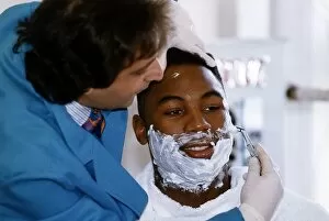 Images Dated 28th February 1993: Lennox Lewis Boxing Heavyweight Boxer sitting down being shaved 28th February 1993