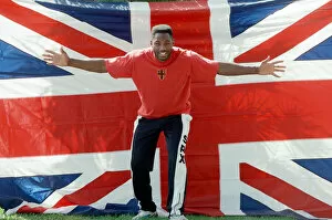 Images Dated 1st May 1993: Lennox Lewis poses with a hug England flag ahead of his WBC world title fight with Tony