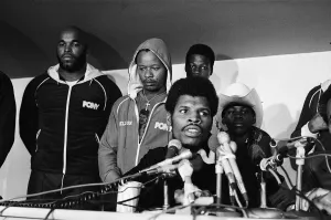 Leon Spinks speaking at a press conference (flanked by body guard Mr T left Leon Spinks speaking at a press conference (flanked by body guard Mr T left