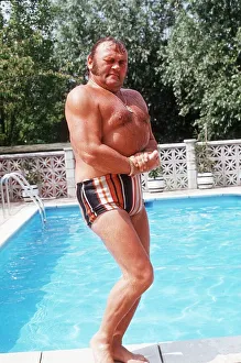 Les Dawson Comedian standing on side of swimming pool at home in St Anne' Les Dawson Comedian standing on side of swimming pool at home in St Anne'