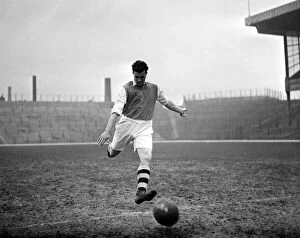 Football Stadium Gallery: Leslie Compton kicks a football at Highbury Arsenal footballer circa 1935