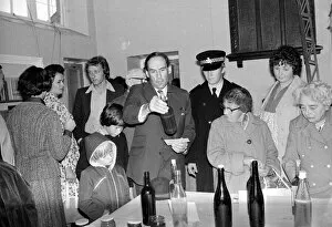 Liberal Party leader Jeremy Thorpe looking at bottles as he visits a flower show