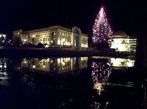Images Dated 8th December 1999: The lights of the newly switched on christmas tree, reflect in a puddle with Baskerville