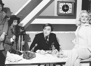 Linda Cunningham Actress Dbase Sitting on table with legs crossed wearing Linda Cunningham Actress Dbase Sitting on table with legs crossed wearing