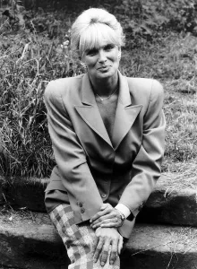 Linda Evans American Actress of Dynasty fame sitting on concrete steps in garden Linda Evans American Actress of Dynasty fame sitting on concrete steps in garden
