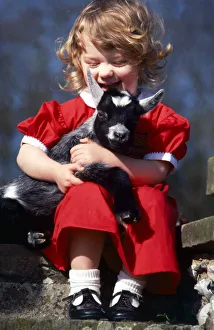 Little girl Candida hugging goat kid April 1981 Little girl Candida hugging goat kid April 1981
