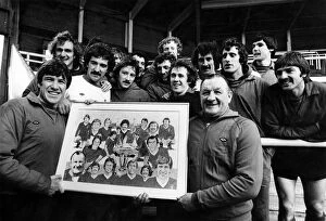 Liverpool football team players holding a photograph of the team
