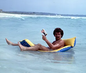 Liverpool footballer Graeme Souness relaxes reading a book on an inflatable bed Liverpool footballer Graeme Souness relaxes reading a book on an inflatable bed