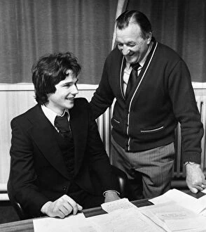 Images Dated 5th May 1977: Liverpool manager Bob Paisley looks on as new defender Alan Hansen officially signs for