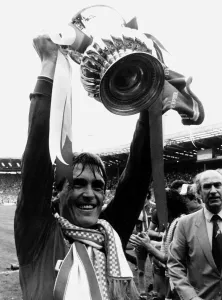 Liverpool player manager Kenny Dalglish holding the trophy aloft after their win against Liverpool player manager Kenny Dalglish holding the trophy aloft after their win against