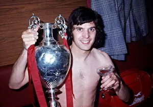 Liverpool player Peter Cormack celebrates winning the League Championship with the trophy