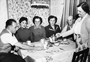 Liverpool full back Ronnie Moran has a cup of tea poured for him bis mother at home Liverpool full back Ronnie Moran has a cup of tea poured for him bis mother at home