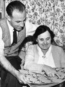 Liverpool full back Ronnie Moran looking through a scrapbook kept by his mother at home Liverpool full back Ronnie Moran looking through a scrapbook kept by his mother at home