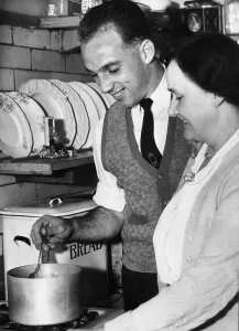 Liverpool full back Ronnie Moran sampling the cooking of his mum in the kitchen at home Liverpool full back Ronnie Moran sampling the cooking of his mum in the kitchen at home
