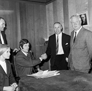 Liverpool's new signing John Toshack from Cardiff City signs his contract accompanied