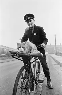 Liverton postman takes his cat on post rounds in Redcar, Cleveland. Circa 1971 Liverton postman takes his cat on post rounds in Redcar, Cleveland. Circa 1971