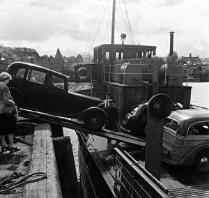 Loading a car onto a ferry steamer at the Quay at Oban. Oban is a resort town within Loading a car onto a ferry steamer at the Quay at Oban. Oban is a resort town within