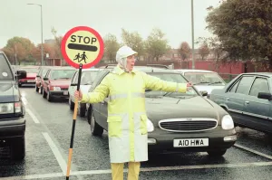 Images Dated 9th November 1995: Lollipop lady Janet Taylor on duty at the junction of Trunk Road with Kings Road