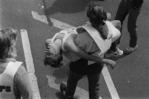 London Marathon one man carrying another in his arms after the race 1984 London Marathon one man carrying another in his arms after the race 1984