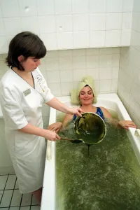 Lorraine Kelly Beauty treatment lying bath green mud being poured in Lorraine Kelly Beauty treatment lying bath green mud being poured in