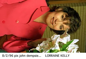 Lorraine Kelly TV presenter wearing a pink suit poses with some flowers Lorraine Kelly TV presenter wearing a pink suit poses with some flowers