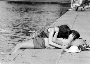 Love and Romance. A young couple oblivious to their surrounding seen here kissing beside Love and Romance. A young couple oblivious to their surrounding seen here kissing beside