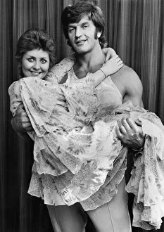 Images Dated 13th October 1973: Lulu being lifted and cuddled by the arms of Strong Man Dave Prowse. October 1973 P035537