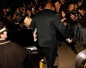 Images Dated 12th October 1992: Madonna actress & singer getting out of a car with her bodyguard The Wall