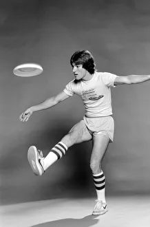 A man performing exercises with a frisbee. June 1980 A man performing exercises with a frisbee. June 1980