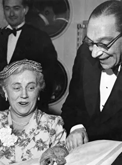 Man showing off a chicken drumstick to a woman at a dinner party Circa 1955 Man showing off a chicken drumstick to a woman at a dinner party Circa 1955