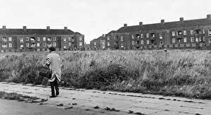 Man walking down a street in the residential suburb f Speke in South Liverpool Man walking down a street in the residential suburb f Speke in South Liverpool