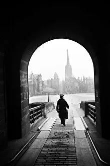 A man who helps operate the Time Gun walking through the entrance archway to Edinburgh