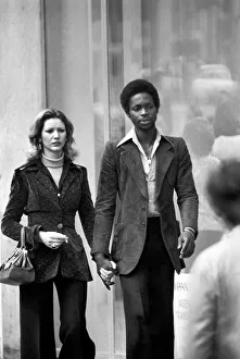 Man and woman walking through the streets of Paris, France Man and woman walking through the streets of Paris, France