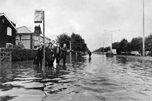 Manchester Schoolboys waiting for the next bus on the flooded Kingsway Road in Burnage Manchester Schoolboys waiting for the next bus on the flooded Kingsway Road in Burnage