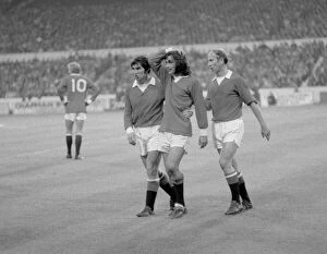 Images Dated 1st December 1971: Manchester United footballer George Best is consoled by teammates Tony Dunne (left