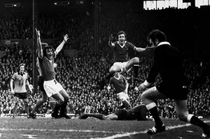Manchester United footballers Lou Macari and Sammy McIlroy celebrates a goal by Gerry Manchester United footballers Lou Macari and Sammy McIlroy celebrates a goal by Gerry