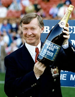 00468 Gallery: Manchester United manager Alex Ferguson holding a bottle of champagne