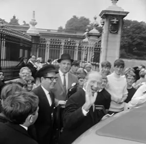 Manchester United manager Matt Busby waves as he arrives at Buckingham Palace to be Manchester United manager Matt Busby waves as he arrives at Buckingham Palace to be