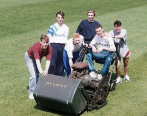 Manchester United youth team players surrounding a lawnmower on the pitch at The Cliff Manchester United youth team players surrounding a lawnmower on the pitch at The Cliff