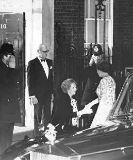 Margaret Thatcher curtsying to the Queen outside 10 Downing Street watched by Denis Margaret Thatcher curtsying to the Queen outside 10 Downing Street watched by Denis