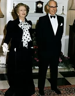 Images Dated 4th December 1985: Margaret Thatcher Prime Minister with her husband Denis Thatcher in evening dress