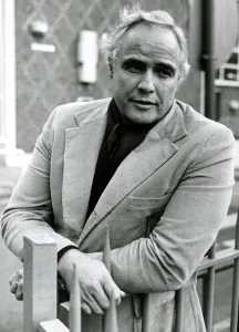 Images Dated 25th April 1977: Marlon Brando, Film Star, Movie Icon, leaning against railings outside BBC Television