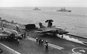 McDonnell Douglas Phantom FG1 (F-4K) of 892 Naval Air Sqd waits as a Blackburn Buccaneer McDonnell Douglas Phantom FG1 (F-4K) of 892 Naval Air Sqd waits as a Blackburn Buccaneer