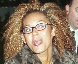 Images Dated 23rd January 1997: Mel B of the Spice Girls showing the two rings in her tongue as she went through Heathrow