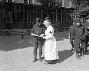 A member of the Belgian Civil Guard seen here in Brussels with Red Cross nurse Circa A member of the Belgian Civil Guard seen here in Brussels with Red Cross nurse Circa